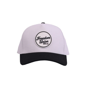 White snapback cap with black visor and Freedom Union logo patch