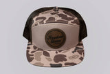Camouflage trucker hat with 'Freedom Union' logo on a light gray background