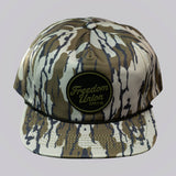 Camouflage-patterned cap with 'Freedom Union' logo on a light gray background
