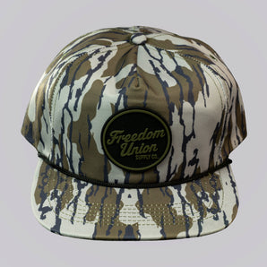 Camouflage-patterned cap with 'Freedom Union' logo on a light gray background