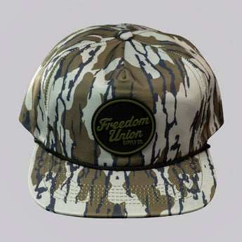 Camouflage-patterned cap with 'Freedom Union' logo on a light gray background