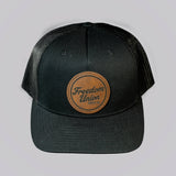 Black cap with a leather patch featuring 'Freedom Union' on a light gray background