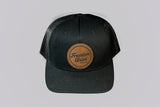 Black cap with a leather patch featuring 'Freedom Union' on a light gray background