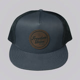 Gray cap with a brown leather patch on a light gray background