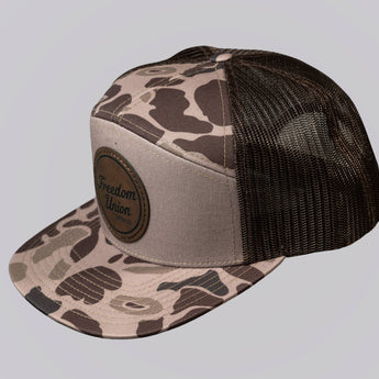 Camouflage-patterned cap with black mesh back on a light gray background