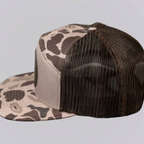 Camouflage-patterned cap with mesh back on a light gray background