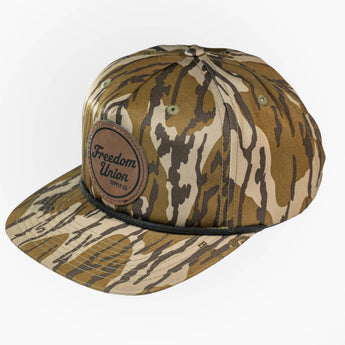Camouflage cap with leather patch on a white background
