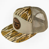 Trucker hat with tiger stripe pattern and beige mesh back on a white background