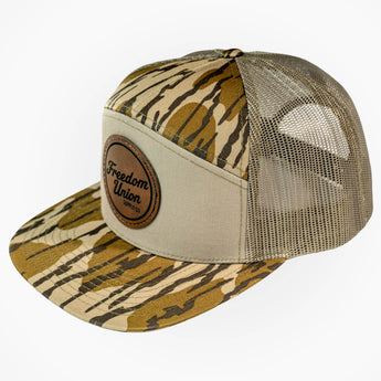 Trucker hat with tiger stripe pattern and beige mesh back on a white background