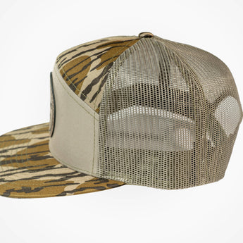 Beige mesh cap with camouflage brim on a white background