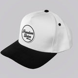 White cap with black brim and logo on a light gray background