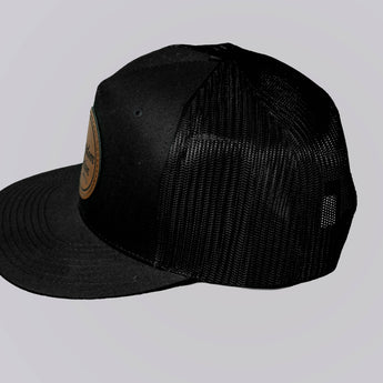 Black mesh cap with a logo on a light gray background