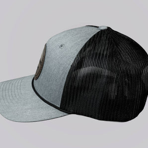 Two baseball caps, one gray and one black, on a light gray background