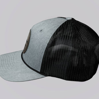 Two baseball caps, one gray and one black, on a light gray background