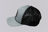 Two baseball caps, one gray and one black, on a light gray background