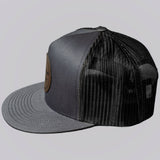 Gray and black trucker cap on a light gray background