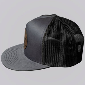Gray and black trucker cap on a light gray background