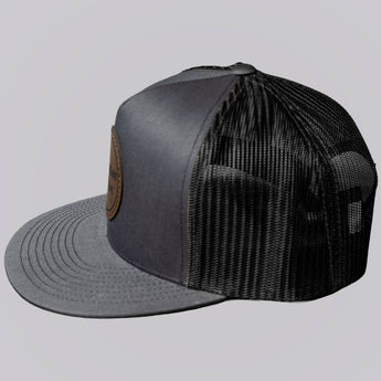 Gray and black trucker cap on a light gray background