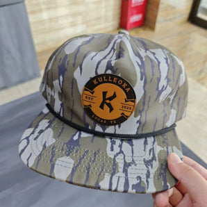 Camo snapback hat with orange Kulleoka Lucas TX patch on front