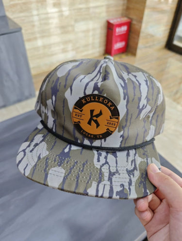 Camo snapback hat with orange Kulleoka Lucas TX patch on front