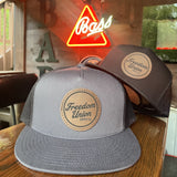 Freedom Union mesh trucker hat with leather patch logo on front