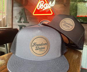 Freedom Union mesh trucker hat with leather patch logo on front