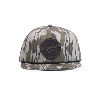 Camo snapback hat with circular black Freedom Union logo patch