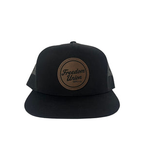 Black snapback hat with mesh back and brown Freedom Union logo patch