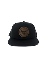 Black snapback hat with mesh back and brown Freedom Union logo patch